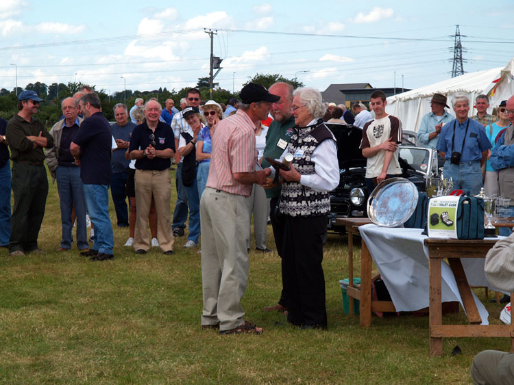 MARGOT PRESENTS THE AUTOTEST WINNER WITH TROPHY